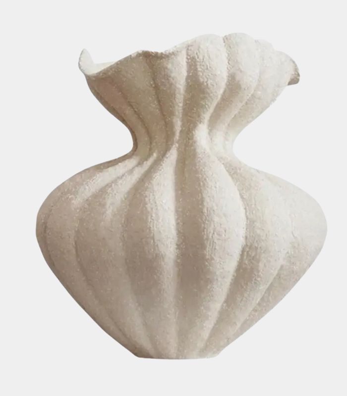 A beige, handcrafted, textured ceramic tabletop vase with a large, bulbous form.