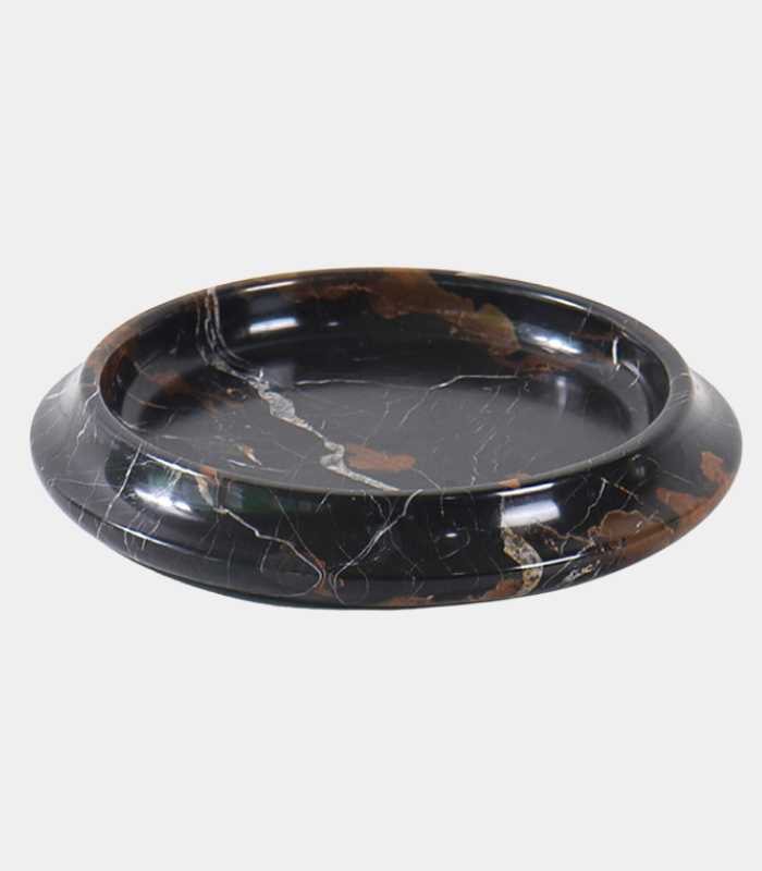 A round, handcrafted marble bowl with a subtle brown tint and veined design, suitable for home decor.