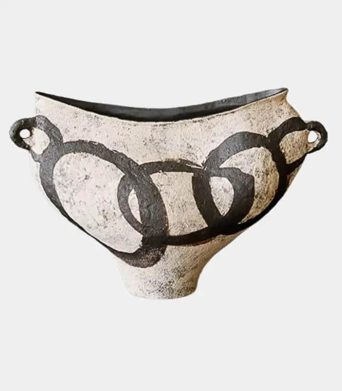 Ceramic bowl with black circular design on a white background