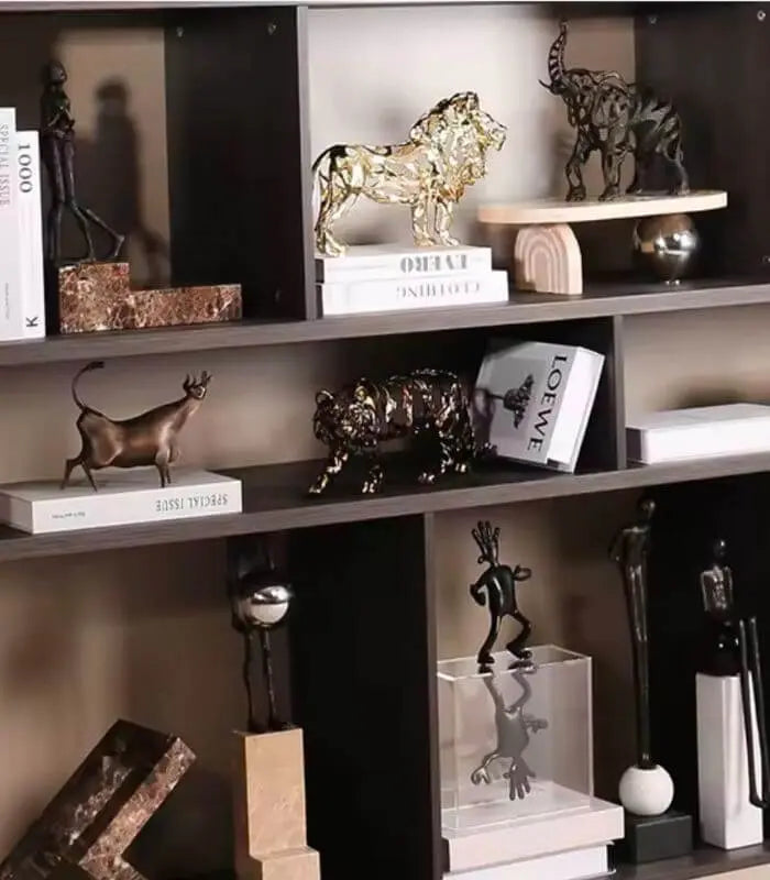 Decorative shelf with various sculptures and books